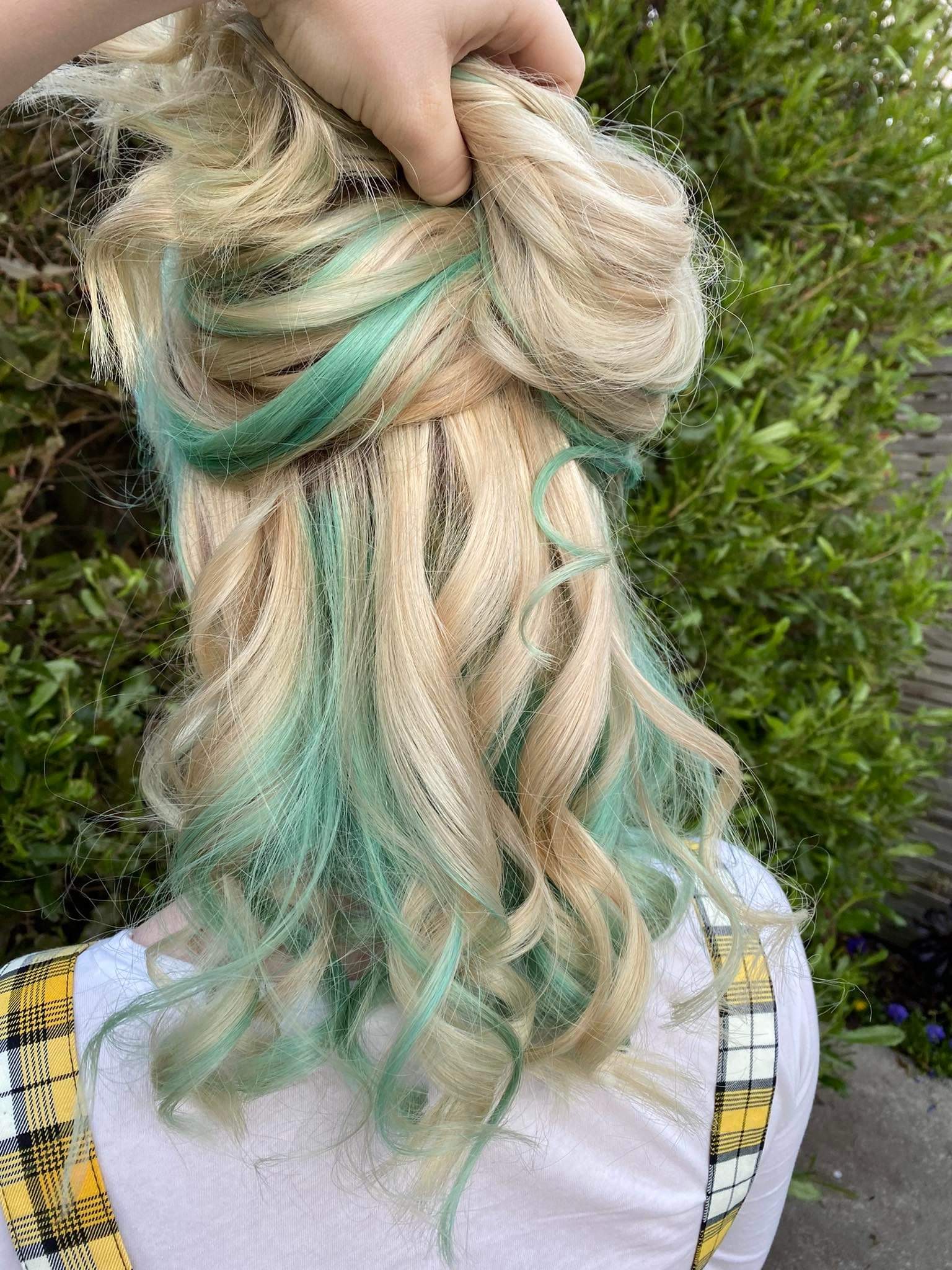 Blonde hair with blue streaks curled